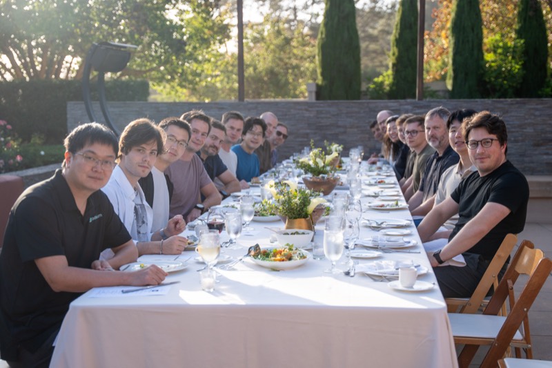 The River team gathered around an outdoor table at a company offsite