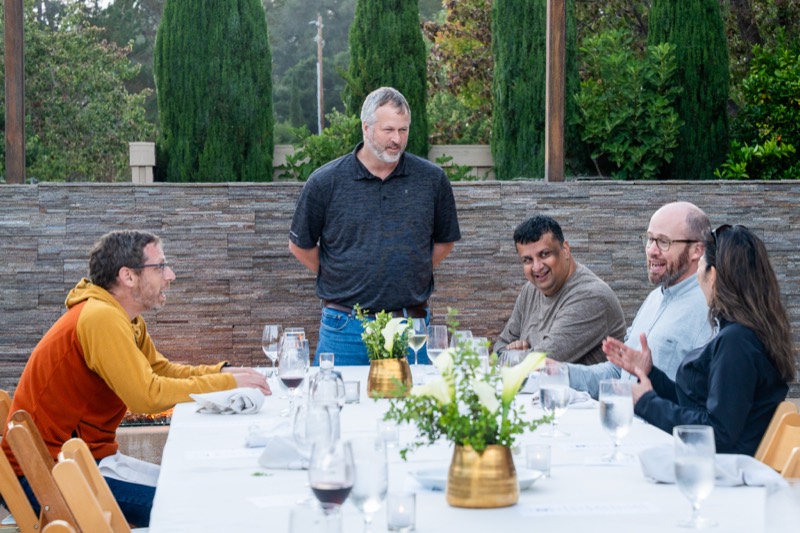 Team members talking around the dinner table