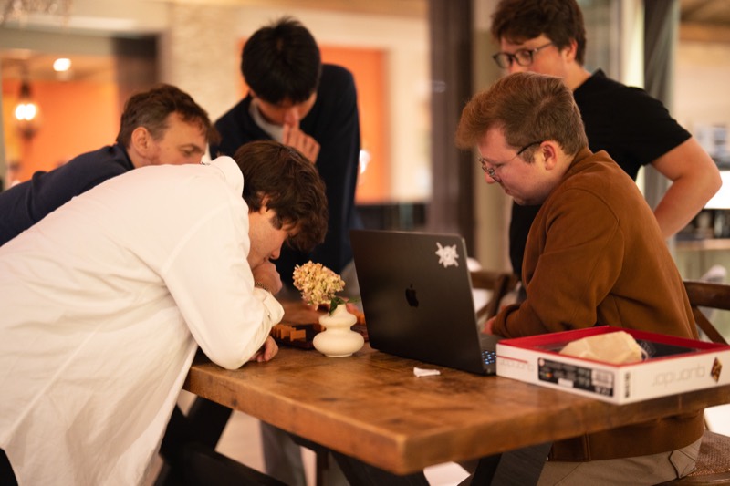 Team members huddled around a laptop together