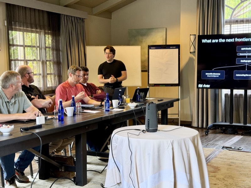 A talk on the next frontiers of AI in the offsite conference room